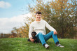 Cute smart dog and his owner young handsome man have fun in the park, conceptions animals, pets, friendship, togetherness
